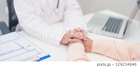 doctor holding hands with elderly female patient, showing empathy and support during a medical consultation. trust, Senior and geriatric care, healthcare, Mental Health, giving advice and emotional doctor holding hands with elderly female patient, showing empathy and support during a medical consultation. trust, Senior and geriatric care, healthcare, Mental Health, giving advice and emotional 129234840