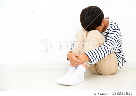 部屋に引き篭もって落ち込む小学生の男の子 部屋に引き篭もって落ち込む小学生の男の子 129235613