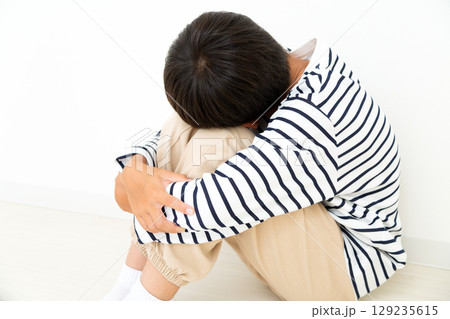 部屋に引き篭もって落ち込む小学生の男の子 部屋に引き篭もって落ち込む小学生の男の子 129235615