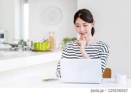 リビングでテレワークをする若い女性。 129236087
