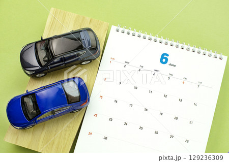 Automotive work desktop with calculator and cell phone 129236309