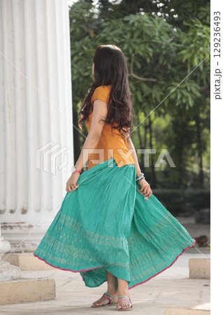 Graceful Indian Woman DGraceful Indian Woman Draped in Traditional Sareeraped in Traditional Saree 129236493