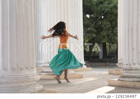 Graceful Indian Woman DGraceful Indian Woman Draped in Traditional Sareeraped in Traditional Saree 129236497