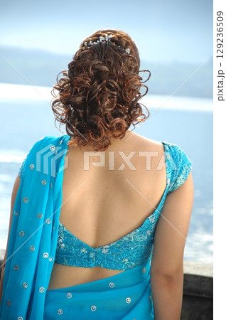 Graceful Indian Woman DGraceful Indian Woman Draped in Traditional Sareeraped in Traditional Saree 129236509