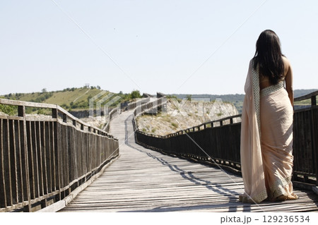 Graceful Indian Woman Draped in Traditional Saree Graceful Indian Woman Draped in Traditional Saree 129236534