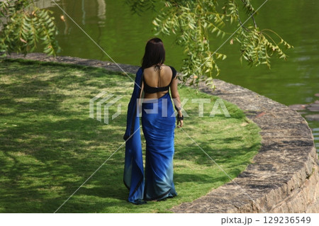 Graceful Indian Woman Draped in Traditional Saree Graceful Indian Woman Draped in Traditional Saree 129236549