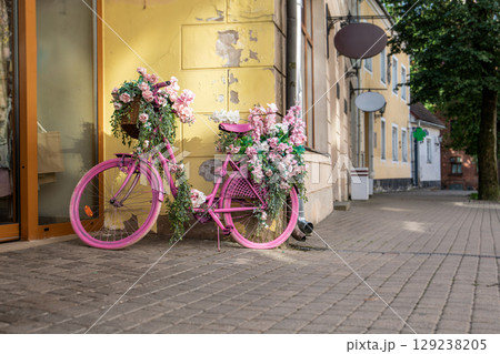 Vintage Pink Bicycle Decorated with Summer Flowers Outdoors 129238205