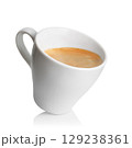 Small inclined espresso cup filled with freshly brewed coffee, featuring rich crema on top, isolated on white background 129238361