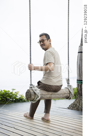 ブランコに乗る男性 129239018