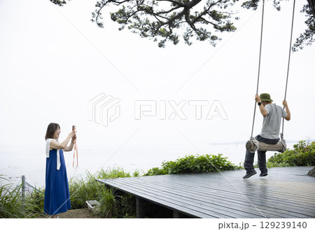 ブランコで遊ぶ夫婦 129239140