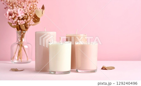 Healthy spa still life with a pink flower, candle flame, pink background Healthy spa still life with a pink flower, candle flame, pink background 129240496