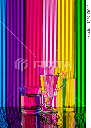 Abstract still life with a glass of water on a color bright background Abstract still life with a glass of water on a color bright background 129243049