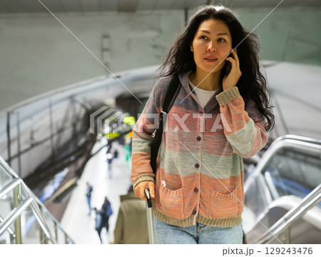 Woman traveler at hall of subway station Woman traveler at hall of subway station 129243476