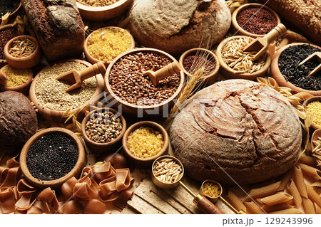 Whole grains concept background. Colorful mix of grain varieties: oat and wheat, rice and millet, buckwheat and barley, quinoa and polenta. Food ingridients for healthy diet. Selective focus 129243996