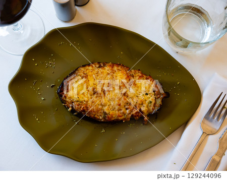 Fresh stuffed eggplant served on dining table 129244096