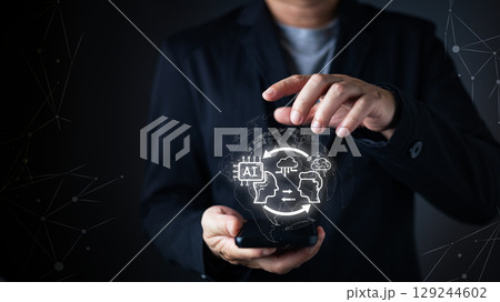 person interacts with a smartphone,projecting a glow AI digital interface.futuristic features artificial intelligence,cloud computing, and machine learning icons,symbol advanced tech and intelligence. 129244602