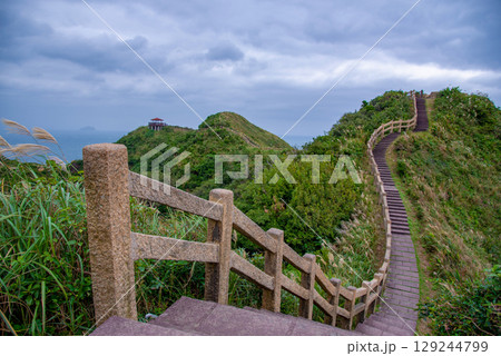 Jiufen Old Street is a narrow, winding alleyway with shops, teahouses, and restaurants that offers tourists a view of traditional Taiwanese life. 129244799