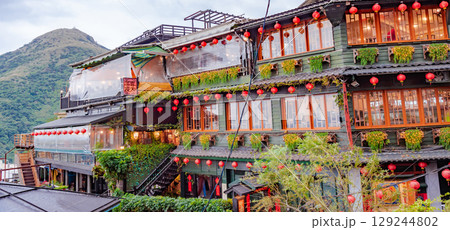Jiufen Old Street is a narrow, winding alleyway with shops, teahouses, and restaurants that offers tourists a view of traditional Taiwanese life. 129244802