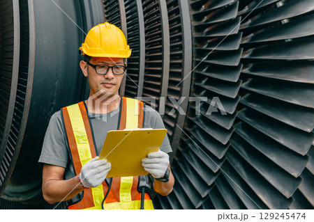 Professional Asian engineer male working service power plant turbine fan blade electrical generator 129245474