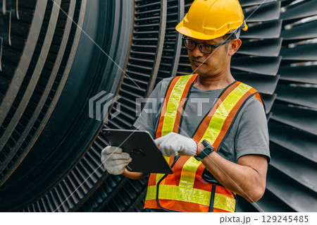 Professional Asian engineer male working service power plant turbine fan blade electrical generator 129245485