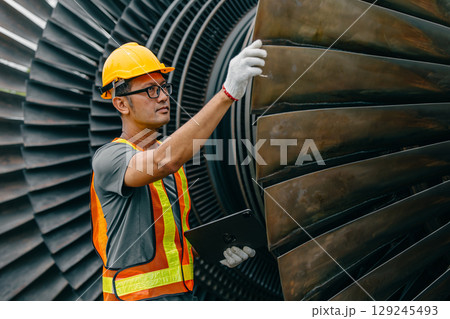 Professional Asian engineer male working service power plant turbine fan blade electrical generator Professional Asian engineer male working service power plant turbine fan blade electrical generator 129245493