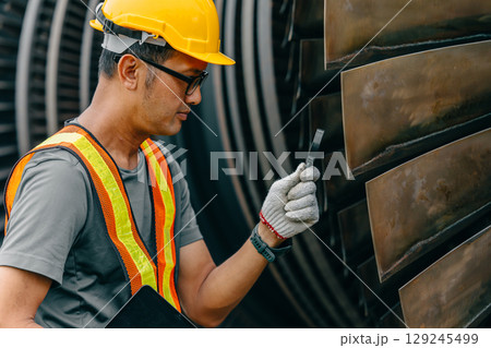 Professional Asian engineer male working service power plant turbine fan blade electrical generator 129245499