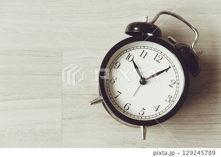 Bell clock old retro style at wooden background with copy space for text, history memory time 129245789