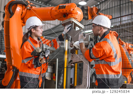 Technician engineer team fix service maintenance inspection robot arm installation in factory. Technician engineer team fix service maintenance inspection robot arm installation in factory. 129245834
