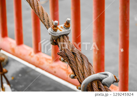 Old Rust Bridge Ungalvanized Steel Wire Rope, Old rusty weathered sling wire poor and danger Old Rust Bridge Ungalvanized Steel Wire Rope, Old rusty weathered sling wire poor and danger 129245924