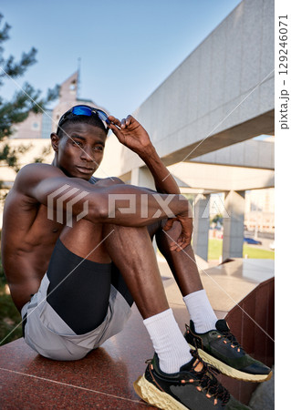 Young athlete resting outdoors during a sunny day 129246071
