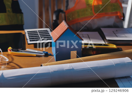Closeup of team of industrial engineers meeting analyze machinery blueprints consult project on table in manufacturing factory. Working in manufacturing plant or production plant. 129246906