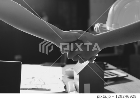 Closeup of team of industrial engineers meeting analyze machinery blueprints consult project on table in manufacturing factory. Working in manufacturing plant or production plant. Closeup of team of industrial engineers meeting analyze machinery blueprints consult project on table in manufacturing factory. Working in manufacturing plant or production plant. 129246929