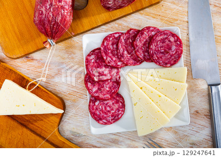 Sliced cured Spanish sausage and cheese on serving plate Sliced cured Spanish sausage and cheese on serving plate 129247641