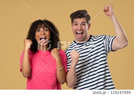 Cheerful african woman man raise fists in victory.Couple celebration, motivation 129247899