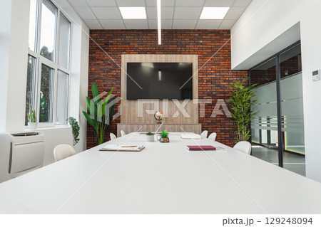 Modern Conference Room With Large Windows and Flat Screen TV Modern Conference Room With Large Windows and Flat Screen TV 129248094