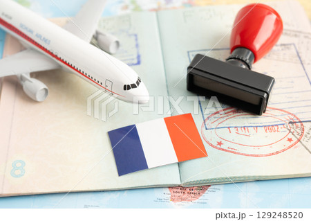 Approved Stamp  passport with France flag document to immigration at airport in country. 129248520