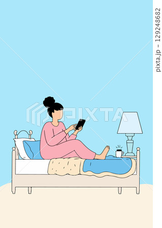 Woman Using Tablet in Bed 129248682