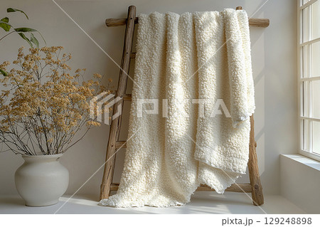 Line of freshly washed white towels hanging on a rack on a Boho style. Line of freshly washed white towels hanging on a rack on a Boho style. 129248898