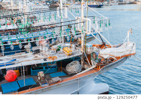 Traditional Fishing Boats Docked at Busan Harbor with Nets and Equipment 129250477