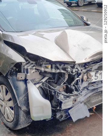 Image of car with serious damage to front end after traffic accident. Close-up Image of car with serious damage to front end after traffic accident. Close-up 129250912