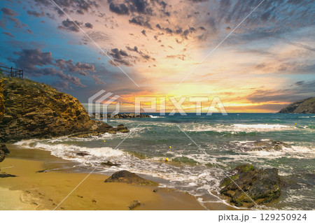 Dynamic coastal landscape showcasing stormy sea and vibrant sunset reflecting climate changes Dynamic coastal landscape showcasing stormy sea and vibrant sunset reflecting climate changes 129250924