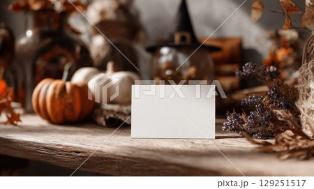 Mockup of white plain greeting, invitation card in Halloween theme background. Product advertising template in minimal style with copy space for Text. Warm color tone. 129251517