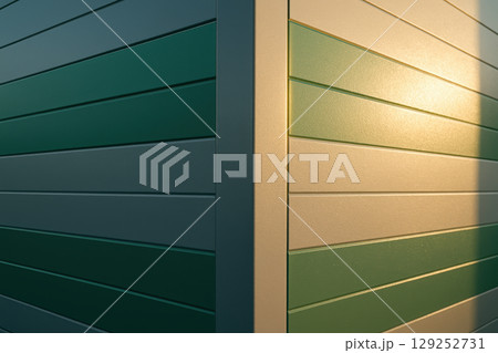 Modern green and white siding panels illuminated by sunlight highlighting clean geometric lines and contemporary architectural, AI Generative 129252731
