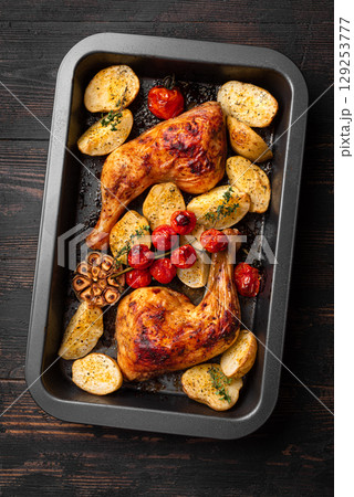 Chicken leg quarters baked with potatoes, tomatoes, garlic and herbs Chicken leg quarters baked with potatoes, tomatoes, garlic and herbs 129253777
