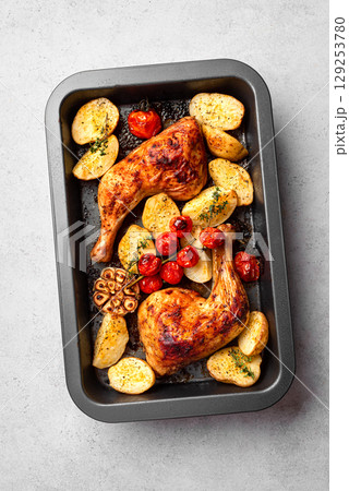 Oven roasted chicken leg quarters with vegetables Oven roasted chicken leg quarters with vegetables 129253780