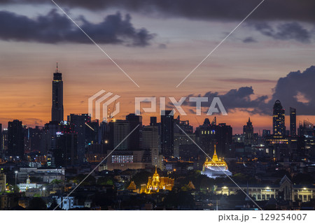 Golden mountain in Wat Saket Ratcha Wora Maha Wihan and Lohaprasat in Wat Ratchanatdaram Worawihan which is landmark in Bangkok, Thailand with bangkok cityscape background. Golden mountain in Wat Saket Ratcha Wora Maha Wihan and Lohaprasat in Wat Ratchanatdaram Worawihan which is landmark in Bangkok, Thailand with bangkok cityscape background. 129254007