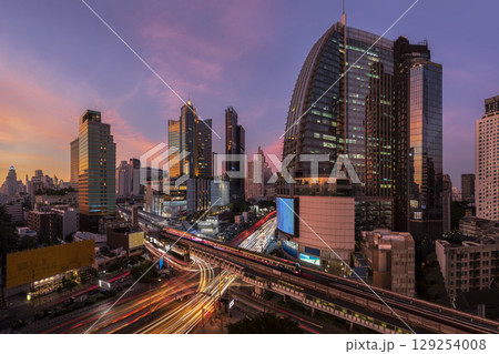 Landscape building modern business district of Bangkok. X-shaped expressway, sky train railway in the foreground at dusk. 129254008
