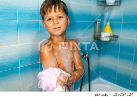Boy taking a bath at home, hygiene and parenting concept Boy taking a bath at home, hygiene and parenting concept 129254124