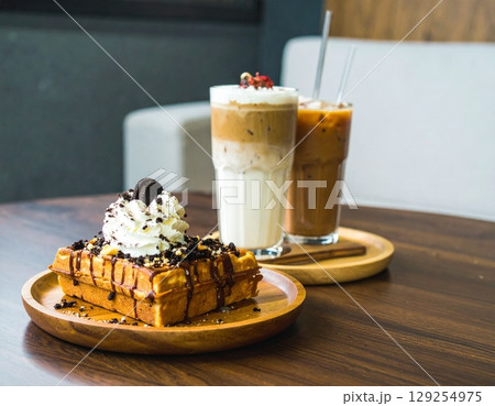 coffee moment, two iced lattes in tall ribbed glass coffee moment, two iced lattes in tall ribbed glass 129254975
