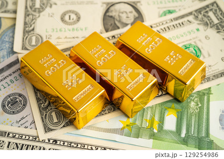 Gold bars with US dollar and Euro banknote money, finance trading investment business currency. Gold bars with US dollar and Euro banknote money, finance trading investment business currency. 129254986